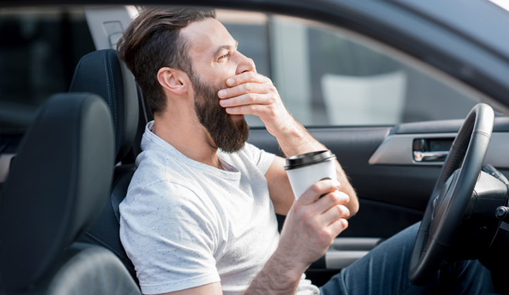 Sleepy Driver Drinking Coffee